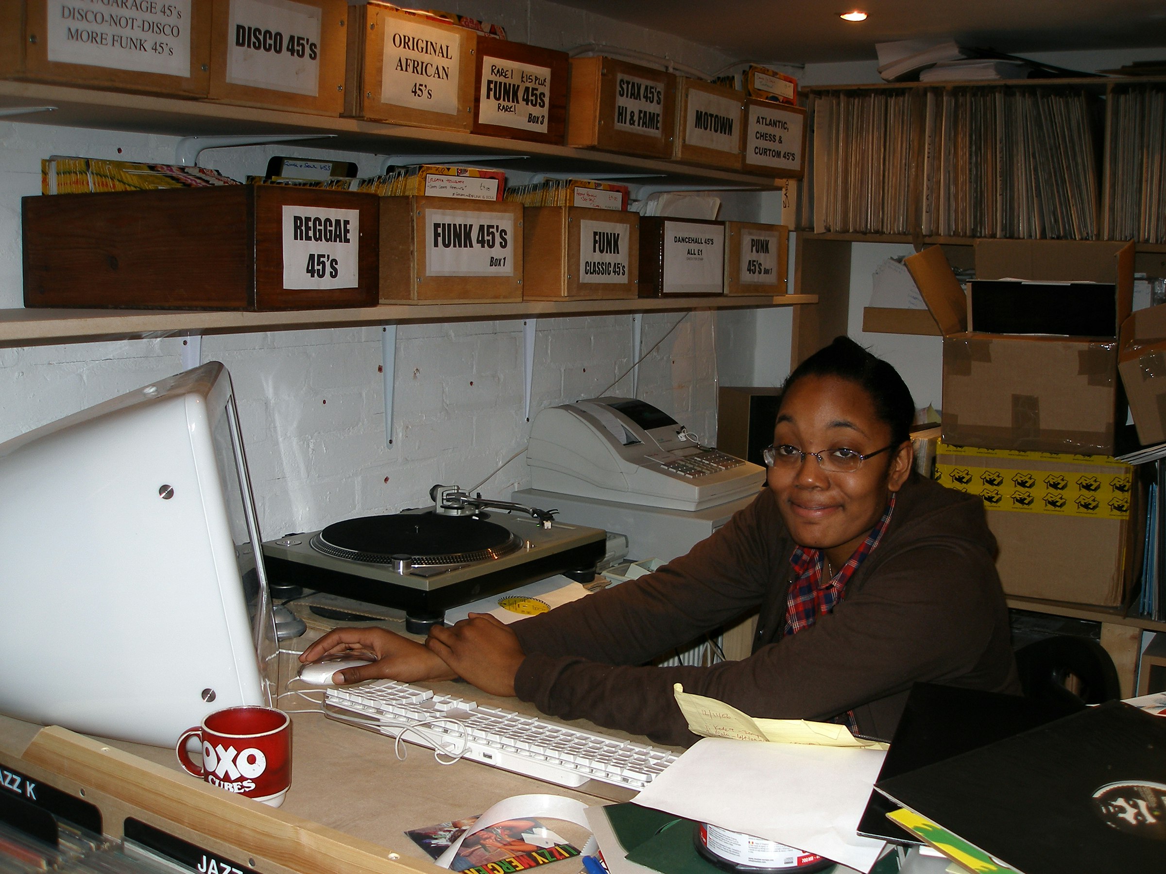 Nicole behind the desk at Sounds of the Universe, March 2005.